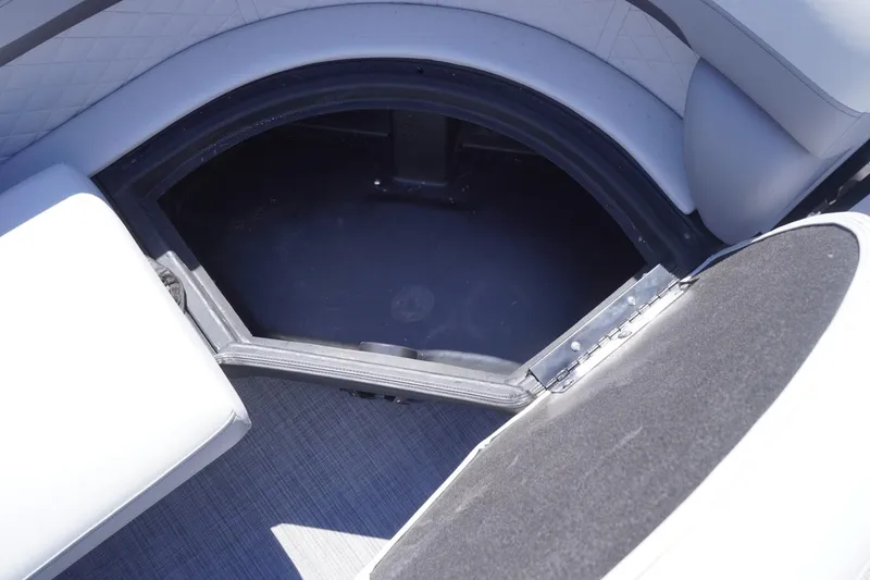 Slide: The Image of Interior storage compartment of 2025 Lowe SS 230 boat, featuring cushioned seating. - 33