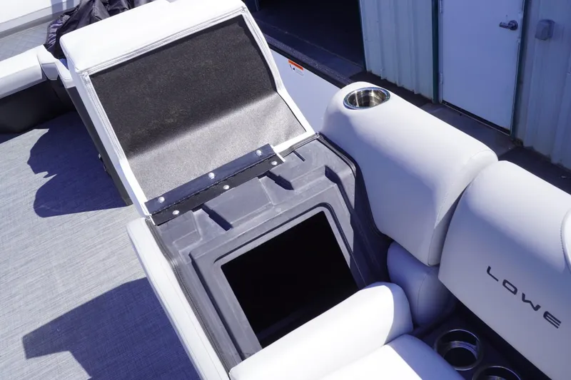Slide: The Image of 2025 Lowe SS 230 boat interior with storage compartment and cup holder. - 36