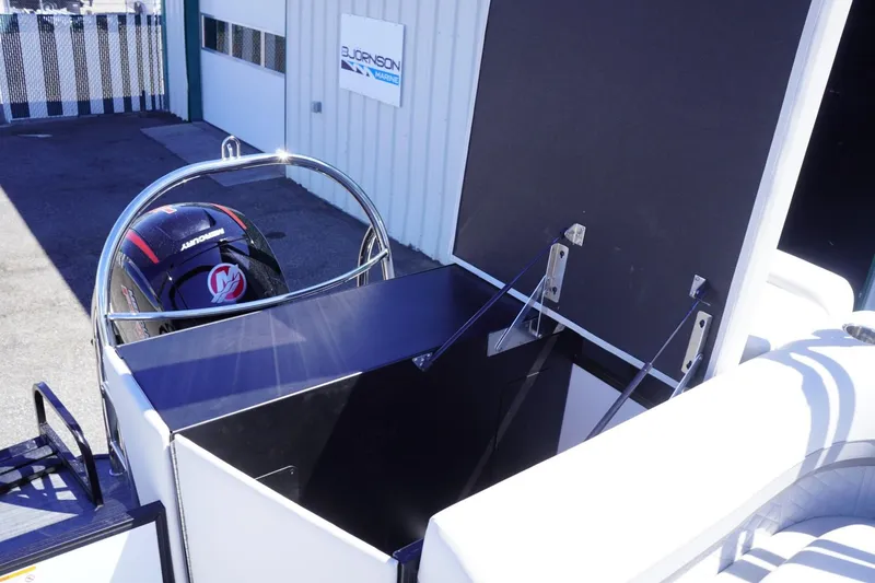 Slide: The Image of 2025 Lowe SS 230 boat with Mercury engine, docked near a building. - 38