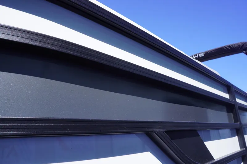 Slide: The Image of 2025 Lowe SS 230 boat exterior with sleek black and white design against a clear blue sky. - 6