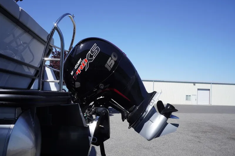 Slide: The Image of Outboard motor on a 2025 Lowe SS 230 boat, parked outdoors. - 9