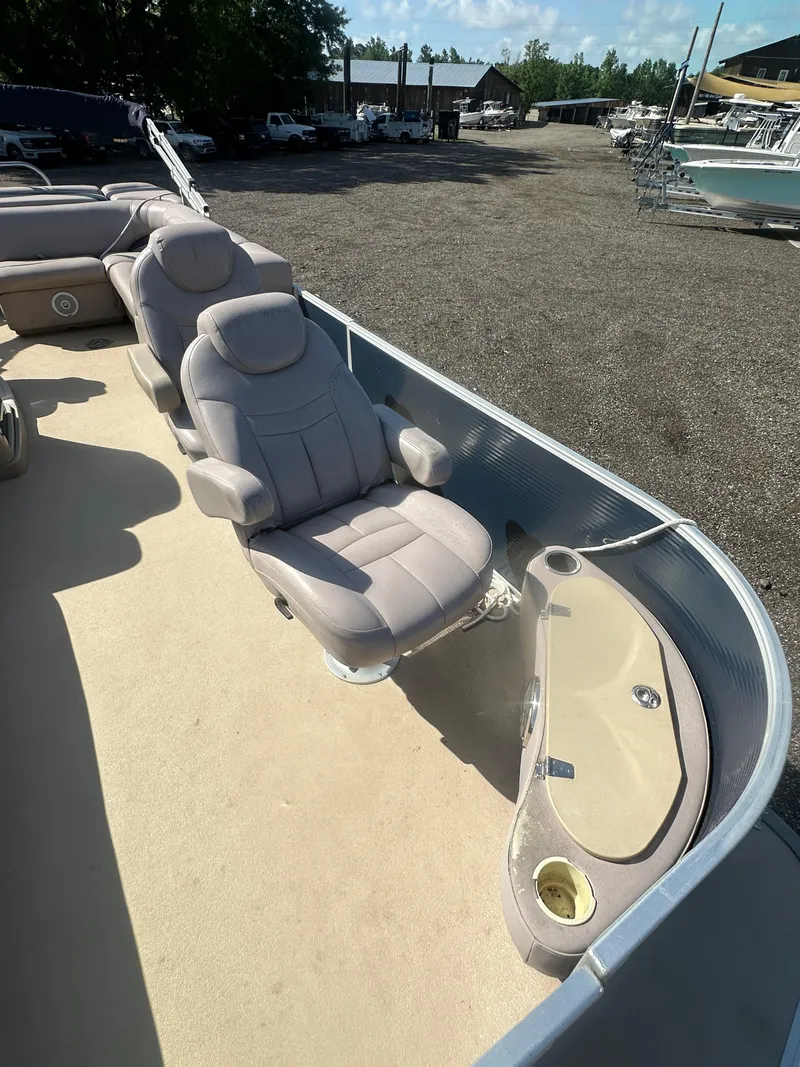 Slide: The Image of 2015 Godfrey Sweetwater 220 Premium Edition boat with beige seating and cup holder. - 12