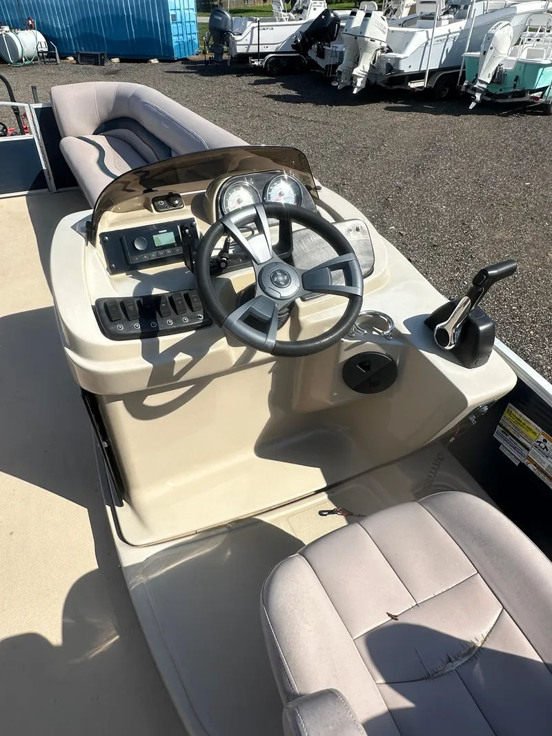 Slide: The Image of 2015 Godfrey Sweetwater 220 Premium Edition boat dashboard and steering wheel. - 18