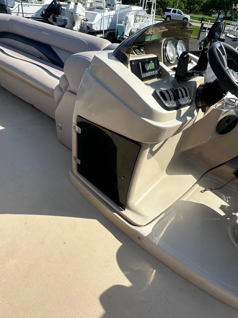 Slide: The Image of 2015 Godfrey Sweetwater 220 Premium Edition boat interior with steering console and seating. - 19