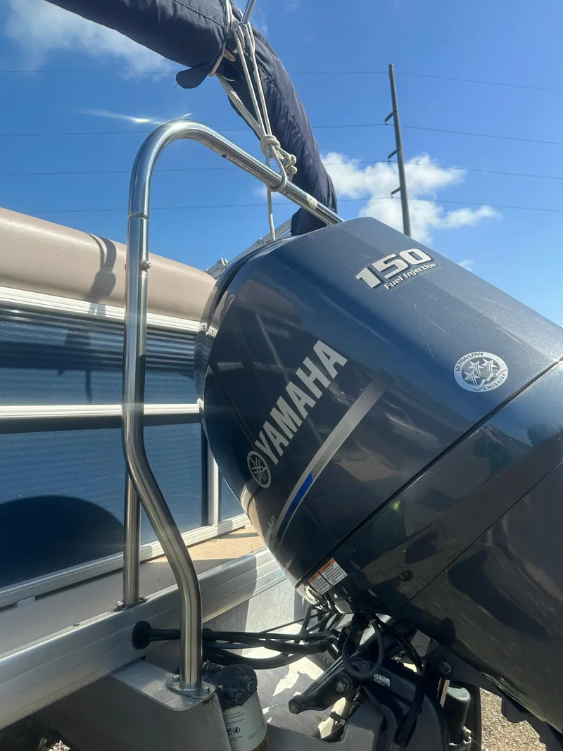Slide: The Image of 2015 Godfrey Sweetwater 220 boat with Yamaha 150 engine under clear blue sky. - 27