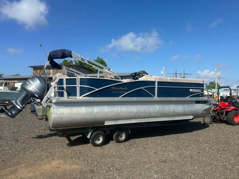 Slide: The Image of 2015 Godfrey Sweetwater 220 Premium Edition pontoon boat on trailer, parked outdoors. - 3