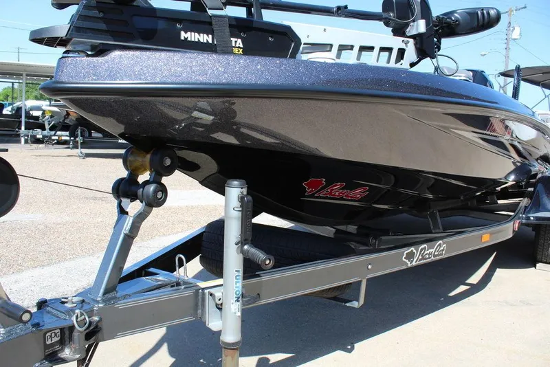 Slide: The Image of 2021 Bass Cat Cougar FTD boat on trailer, featuring sleek design and Minn Kota trolling motor. - 12