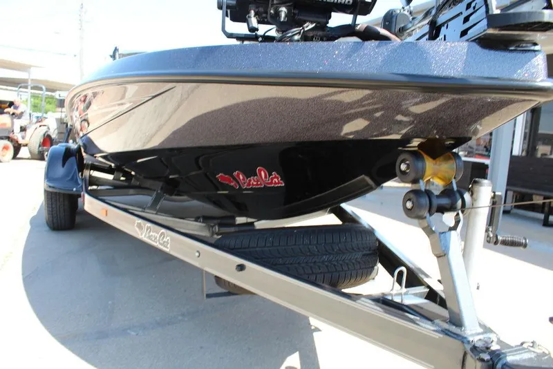 Slide: The Image of 2021 Bass Cat Cougar FTD boat on trailer, showcasing sleek design and sturdy build. - 13