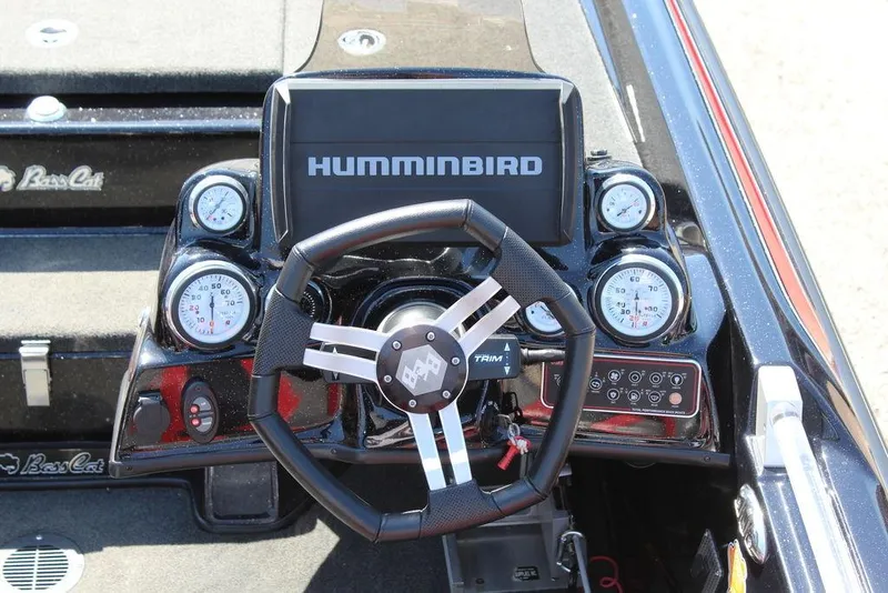 Slide: The Image of 2021 Bass Cat Cougar FTD dashboard with Humminbird display and gauges. - 19