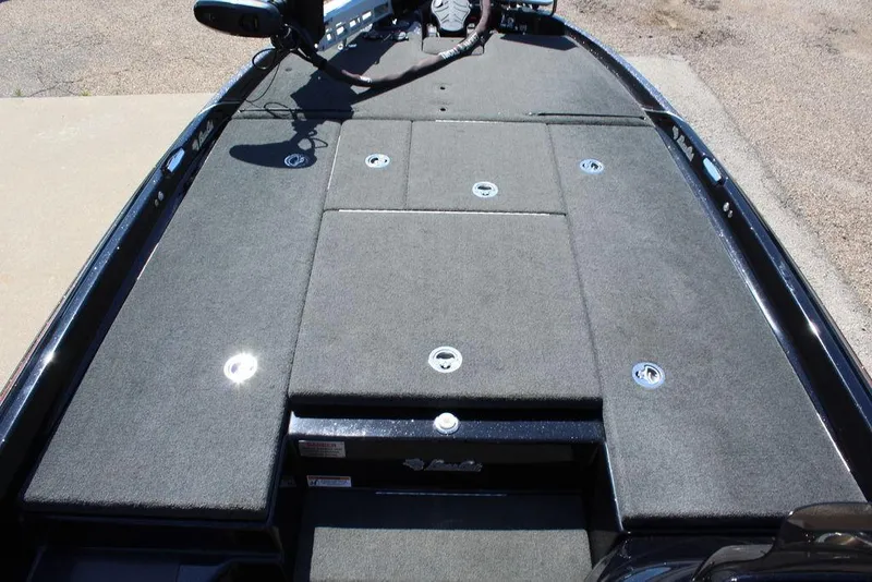 Slide: The Image of 2021 Bass Cat Cougar FTD boat deck with storage compartments and carpeted surface. - 21