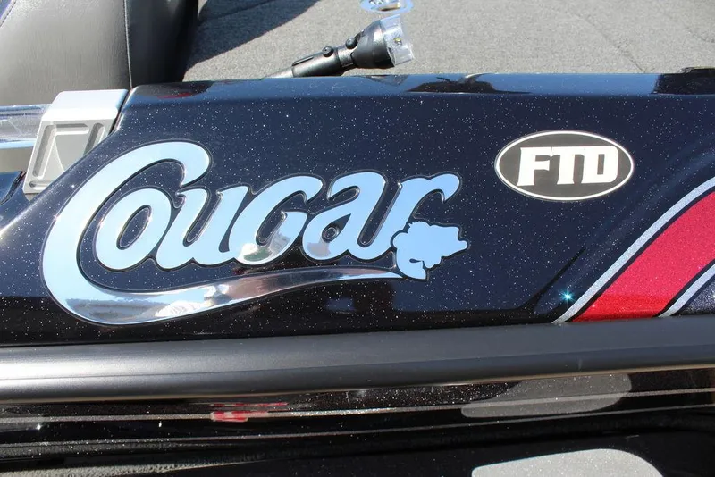 Slide: The Image of Bass Cat Cougar FTD 2021 logo on a sleek black surface. - 24