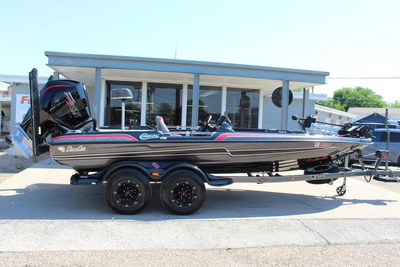 Slide: The Image of 2021 Bass Cat Cougar FTD boat on trailer, parked outside a building. - 4