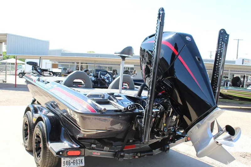 Slide: The Image of 2021 Bass Cat Cougar FTD boat with powerful outboard motor, parked on a trailer. - 6