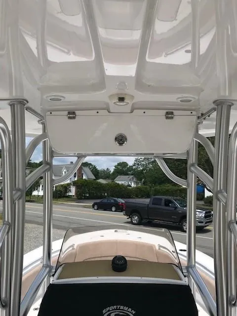 Slide: The Image of 2020 Sportsman Open 232 Center Console boat interior with T-top and street view. - 11