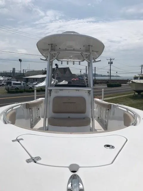 Slide: The Image of 2020 Sportsman Open 232 Center Console boat with T-top, docked outdoors. - 12