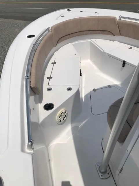 Slide: The Image of 2020 Sportsman Open 232 Center Console boat interior with cushioned seating and stainless steel railings. - 13