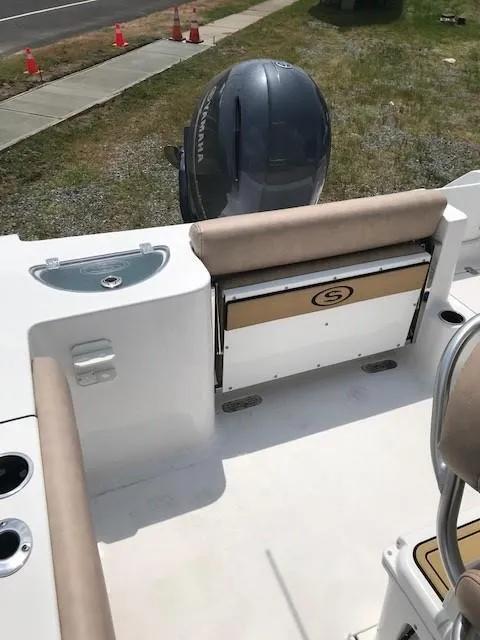 Slide: The Image of 2020 Sportsman Open 232 Center Console boat interior with seating and motor view. - 15
