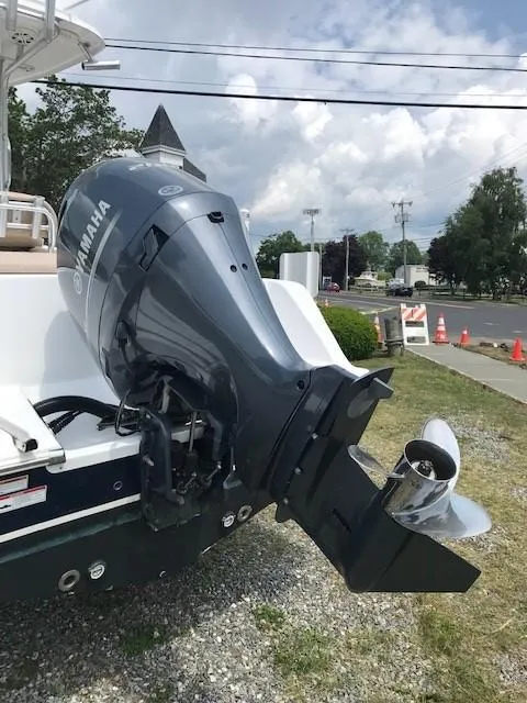Slide: The Image of 2020 Sportsman Open 232 Center Console with Yamaha outboard motor, parked on gravel. - 19