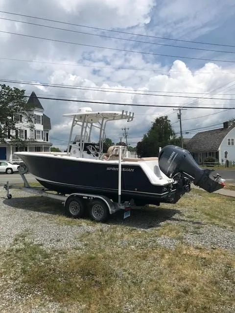 Slide: The Image of 2020 Sportsman Open 232 Center Console boat on trailer, parked outdoors. - 2