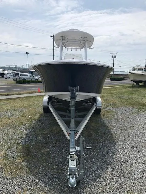 Slide: The Image of 2020 Sportsman Open 232 Center Console boat on trailer, parked on gravel. - 4