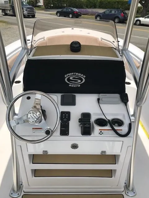 Slide: The Image of 2020 Sportsman Open 232 Center Console boat dashboard with steering wheel and controls. - 5