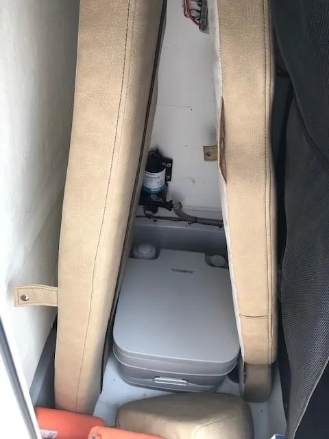 Slide: The Image of 2020 Sportsman Open 232 Center Console boat interior with portable toilet. - 9