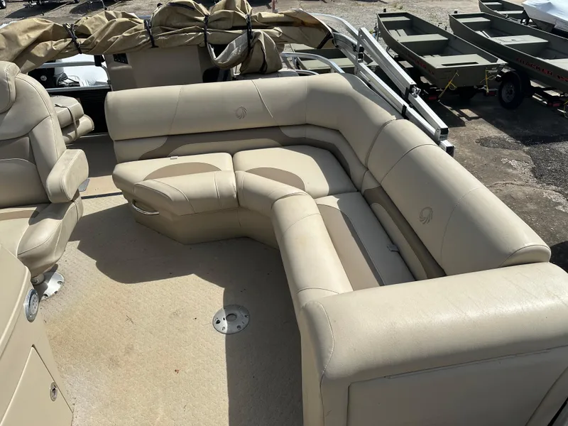 Slide: The Image of 2014 Lowe SF214 Sport Fish boat with beige seating and spacious deck layout. - 10