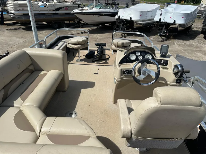 Slide: The Image of 2014 Lowe SF214 Sport Fish boat interior with beige seating and steering console. - 11