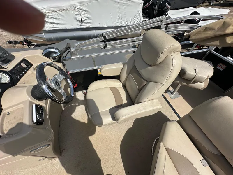 Slide: The Image of 2014 Lowe SF214 Sport Fish boat interior with beige seating and steering wheel. - 15