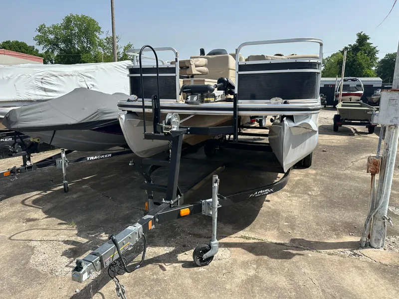 Slide: The Image of 2014 Lowe SF214 Sport Fish pontoon boat on trailer in outdoor storage area. - 6