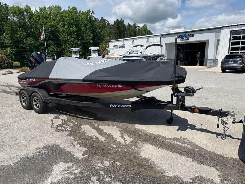 Slide: The Image of 2024 Nitro Z19 boat with cover on trailer, parked outside dealership. - 4