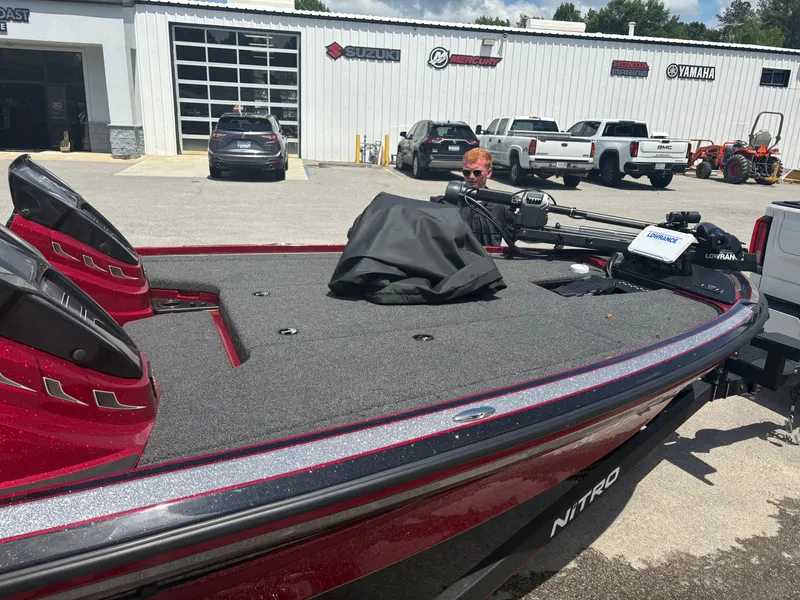 Slide: The Image of 2024 Nitro Z19 boat in a dealership parking lot, showcasing sleek design and modern features. - 9