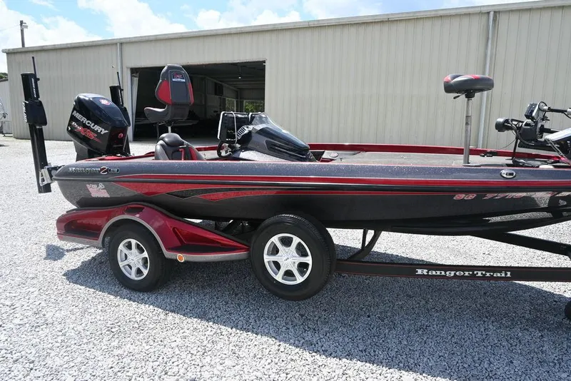 Slide: The Image of 2016 Ranger Z518 boat on trailer, parked on gravel, with visible outboard motor. - 5