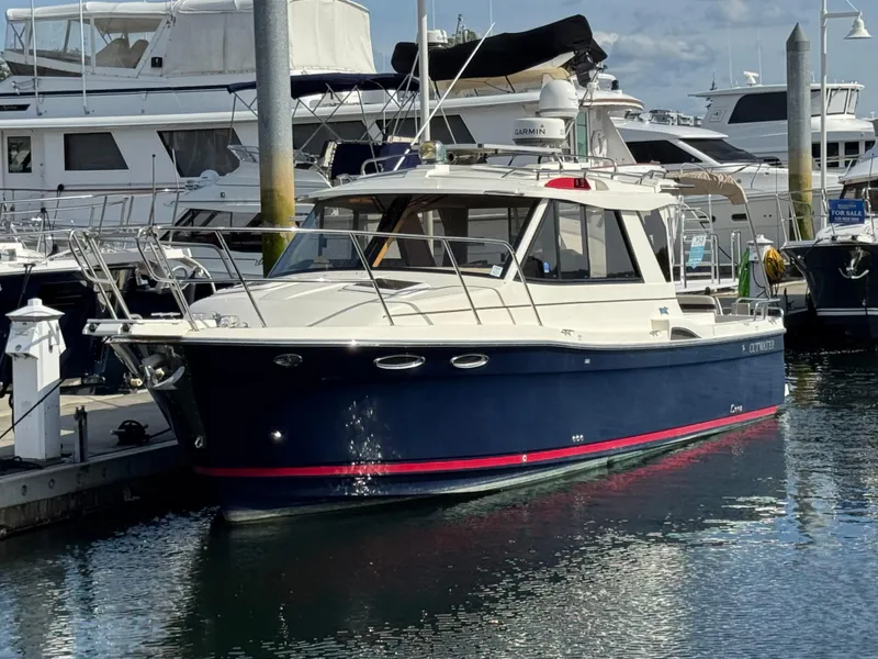 Slide: The Image of 2014 Cutwater C-28 Coupe docked at marina, surrounded by other boats. - 0