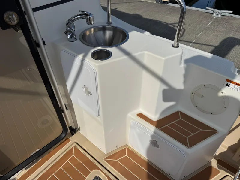 Slide: The Image of 2014 Cutwater C-28 Coupe boat interior with sink and storage compartments. - 10