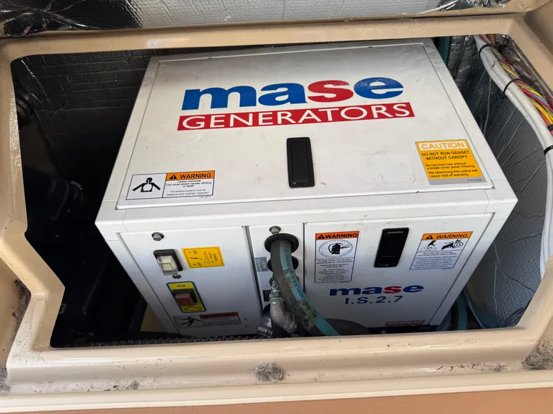 Slide: The Image of Mase generator installed in a 2014 Cutwater C-28 Coupe boat compartment. - 16
