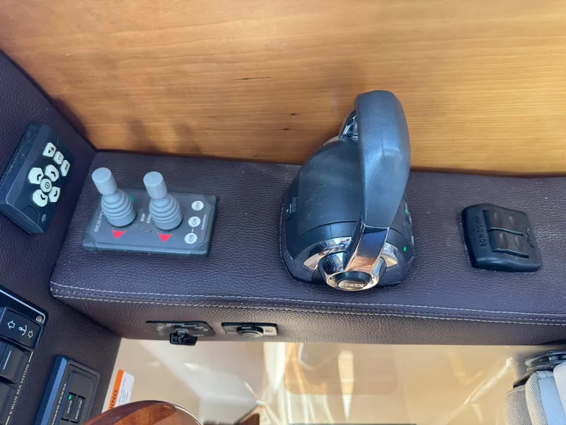 Slide: The Image of Control panel of a 2014 Cutwater C-28 Coupe boat with joystick and throttle. - 24