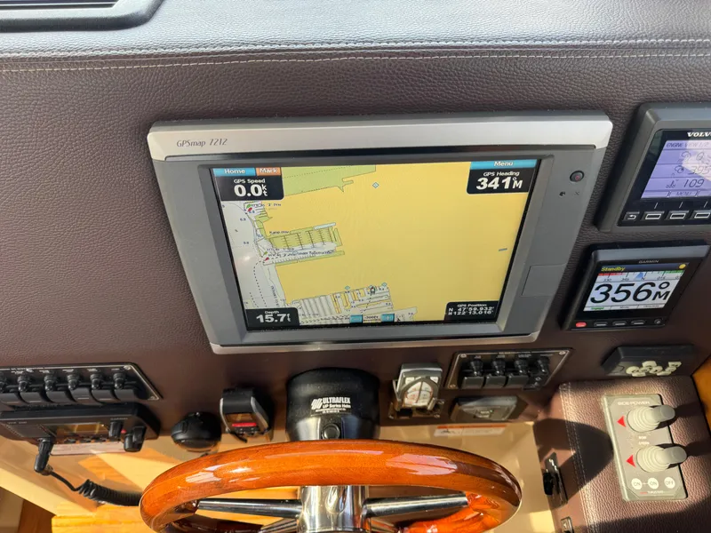 Slide: The Image of Dashboard of a 2014 Cutwater C-28 Coupe with navigation and control instruments. - 26