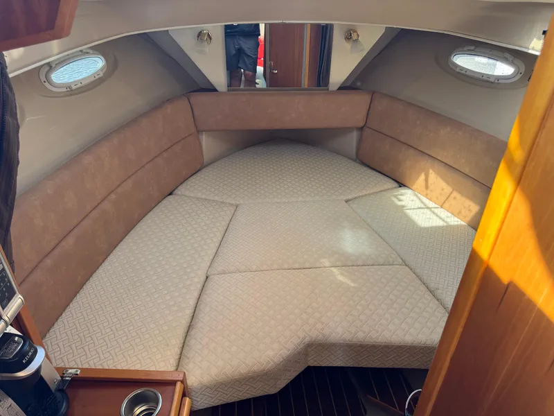 Slide: The Image of 2014 Cutwater C-28 Coupe interior cabin with beige seating and natural light. - 27