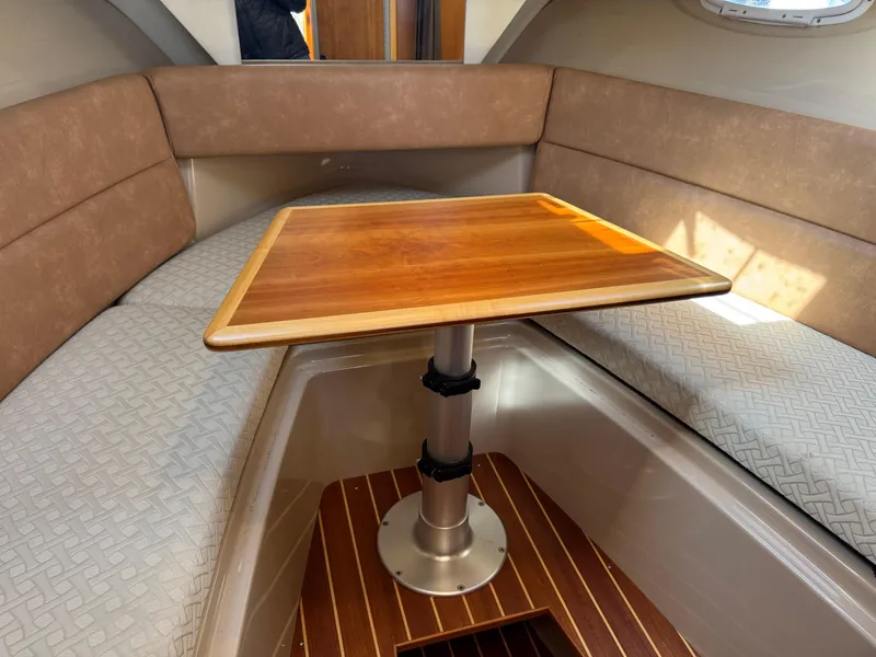 Slide: The Image of 2014 Cutwater C-28 Coupe interior with wooden table and cushioned seating. - 33