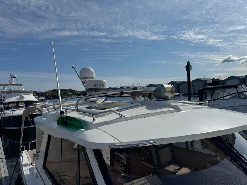 Slide: The Image of 2014 Cutwater C-28 Coupe boat docked, featuring Garmin equipment on the roof. - 36