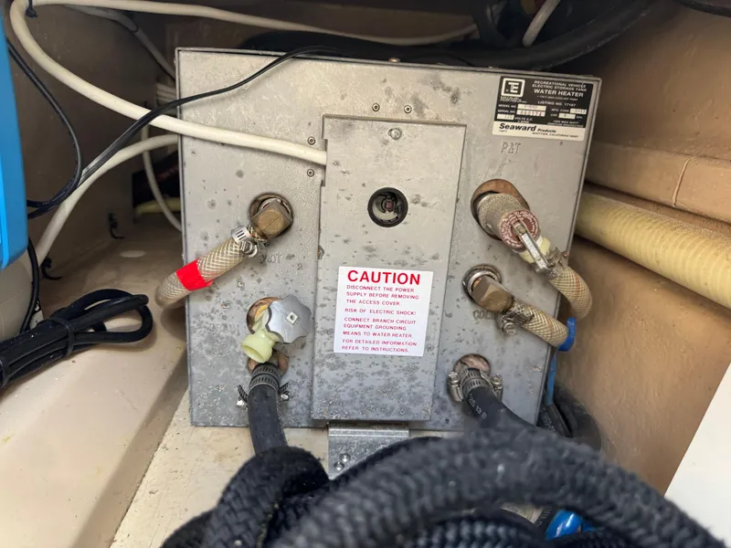 Slide: The Image of Electrical panel with caution label in a 2014 Cutwater C-28 Coupe boat. - 46