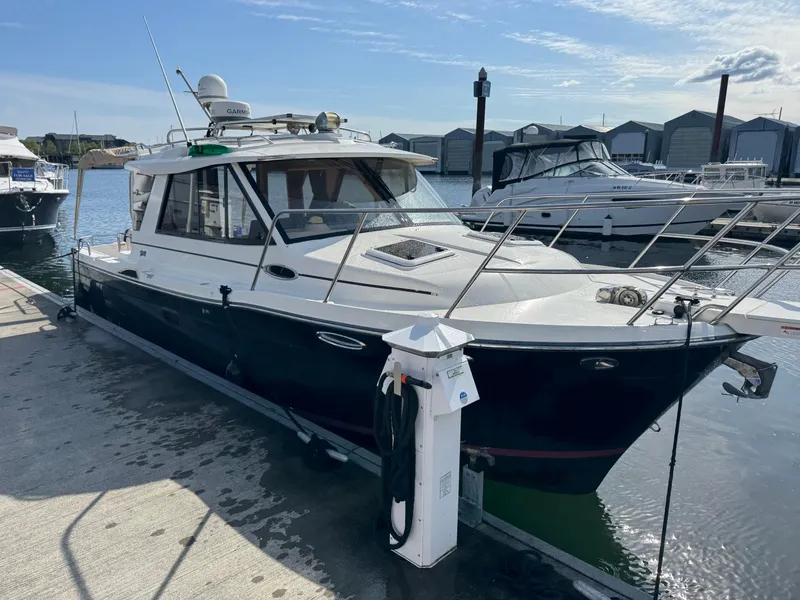 Slide: The Image of 2014 Cutwater C-28 Coupe docked at marina, featuring sleek design and modern amenities. - 5