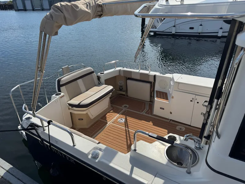 Slide: The Image of 2014 Cutwater C-28 Coupe boat with spacious deck and seating at marina. - 6