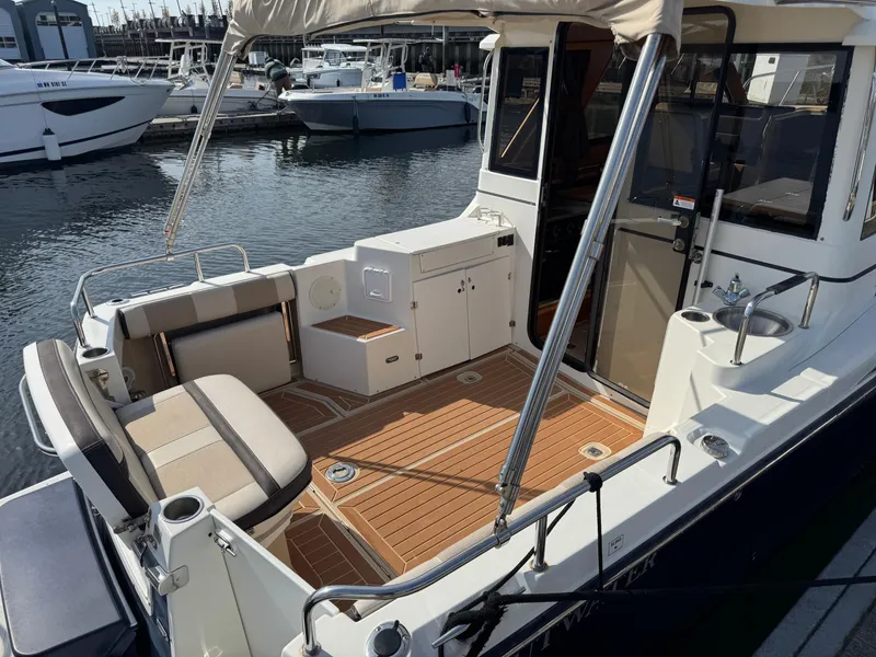 Slide: The Image of 2014 Cutwater C-28 Coupe boat with spacious deck and seating at marina. - 8