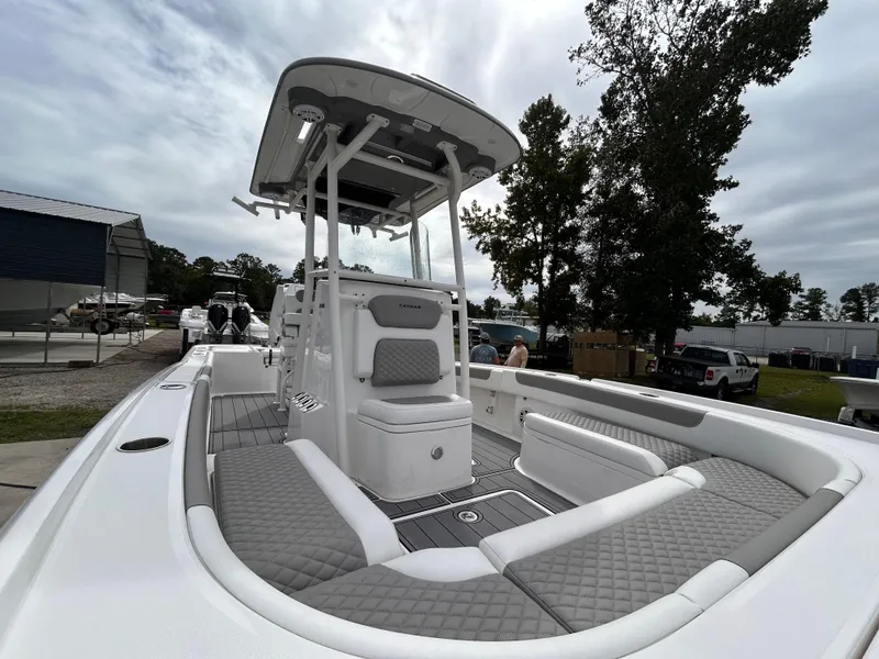 Slide: The Image of 2024 Caymas 26 HB boat with sleek design and spacious seating, docked outdoors. - 3
