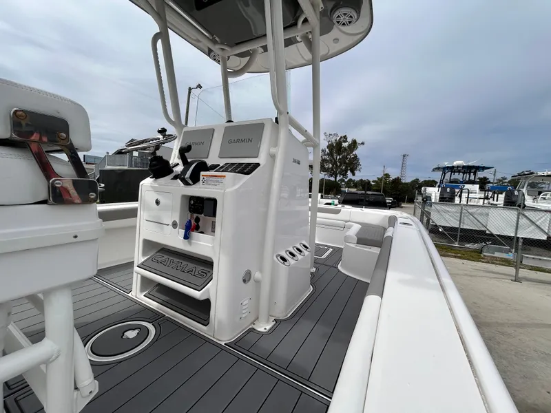 Slide: The Image of 2024 Caymas 26 HB boat with sleek deck and modern console design. - 4