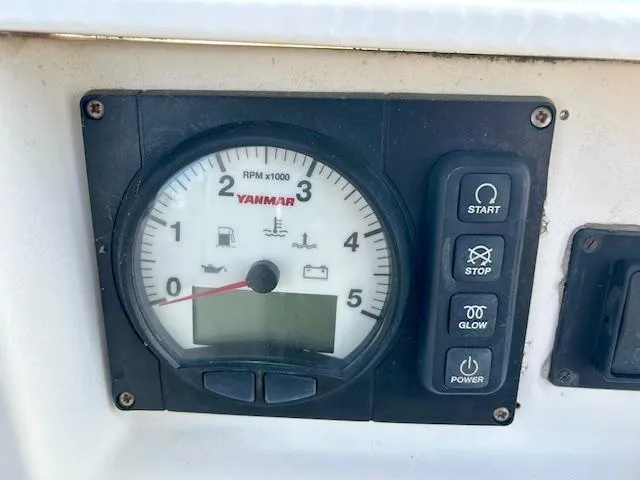 Slide: The Image of Control panel of a 2007 Hanse 400 sailboat with Yanmar tachometer and buttons. - 11