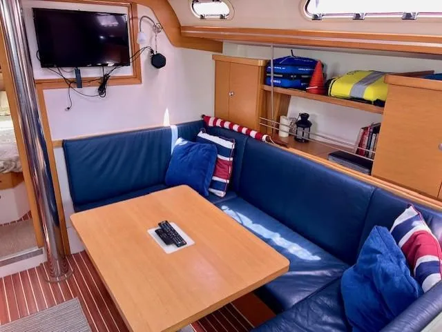 Slide: The Image of Cozy interior of 2007 Hanse 400 yacht with blue seating and wooden table. - 15
