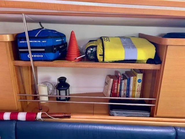 Slide: The Image of Shelf on 2007 Hanse 400 yacht with medical kit, life jacket, books, and lantern. - 16